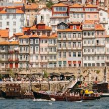 a boat in the water in front of a city