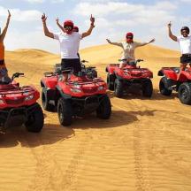 a group of people on atvs in the desert