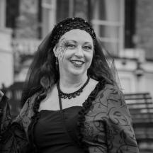a woman is smiling while dressed in a costume