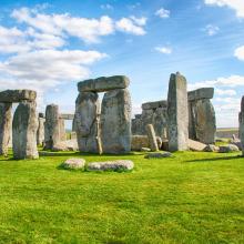 an ancient stonehenge monument with rocks in a field