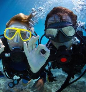 two people in diving gear posing for a picture