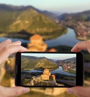 a person holding up a cell phone to take a picture