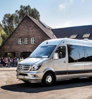 a silver van parked in front of a building
