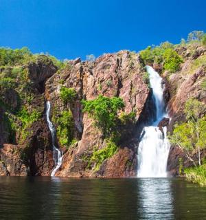 a waterfall on the side of a mountain with water