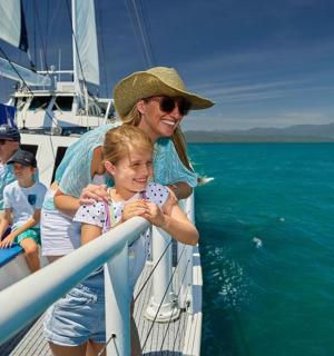 a woman and children on a boat in the water