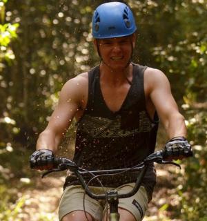 a man riding a bike down a trail