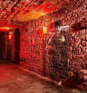a brick hallway with a brick wall with red lights