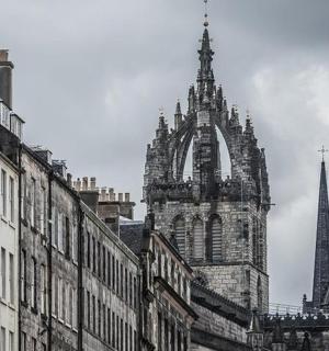 an old building with a tower and a steeple in a city
