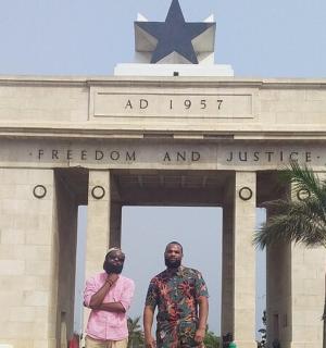 a man and a woman standing in front of a monument