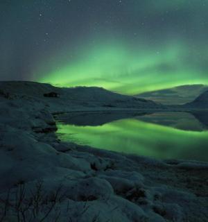 an aurora over a body of water at night