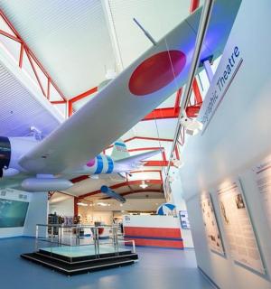 a museum with a plane hanging from the ceiling