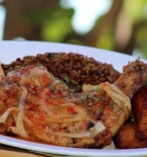 a plate of food with meat and rice on a table