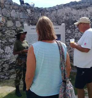 a group of people standing in front of a wall