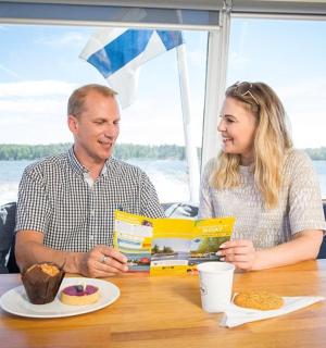 karl og kona sitja við borð og borða mat