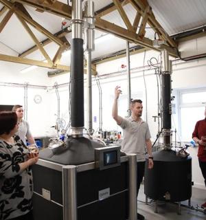 a group of people standing around in a factory