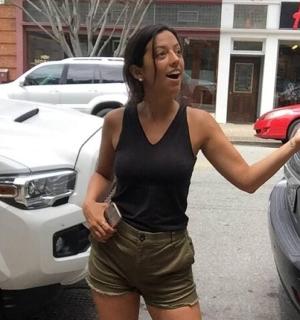 a woman is standing next to a white truck