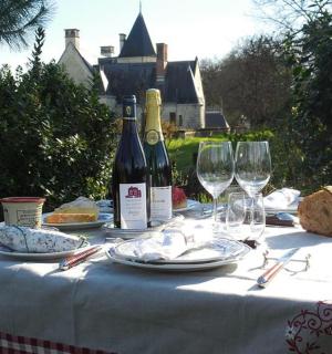 a table with two bottles of wine and glasses