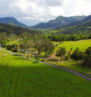 an aerial view of a green field with a road