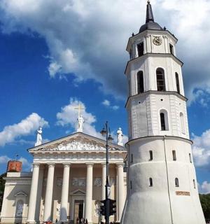 a white building with a clock tower in front of it
