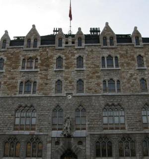 a large brick building with a flag on top