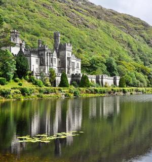 a castle sitting on the side of a lake