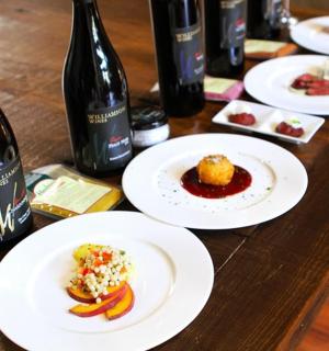 a table with plates of food and bottles of wine