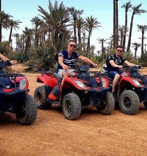 a group of men riding atvs on a dirt field