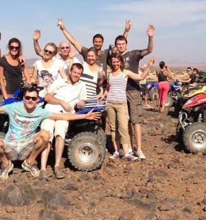 a group of people posing for a picture in the desert