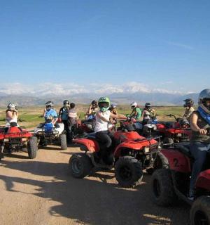 a group of people riding atvs on a dirt road
