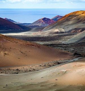 a desert with a winding road in the middle