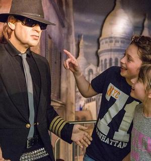 a man and a woman standing next to a man in a hat