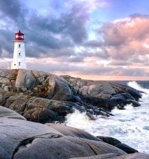 a lighthouse on the rocks near the ocean