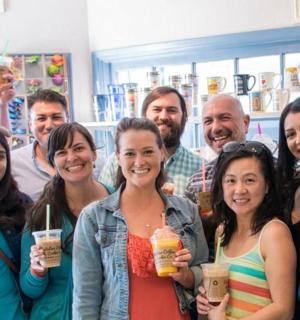 a group of people posing for a picture with drinks