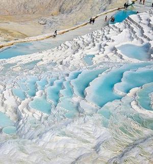a group of people standing on top of a glacier