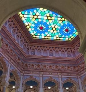 a ceiling with a stained glass window in a building