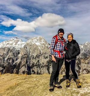 two people standing on the top of a mountain