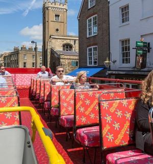 a group of people sitting on a tram in a city