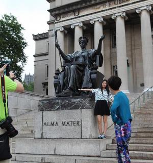 a group of people standing in front of a statue