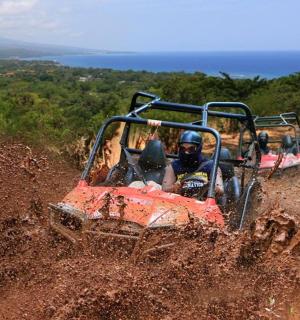 a man riding in an atv on a dirt hill