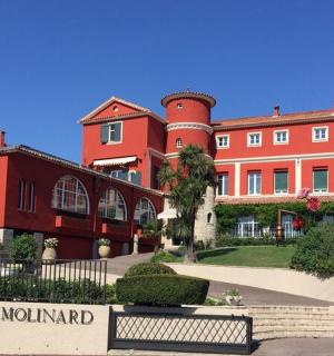 a group of buildings with a park in front of them