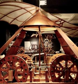 a exhibit of a wagon with wooden wheels and an umbrella
