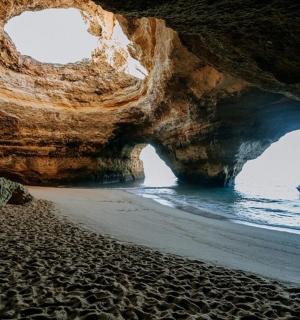 海滩上的一个洞穴,水中有一艘船