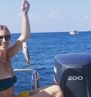 a woman in a bikini on a boat in the water