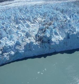 an aerial view of a glacier in a body of water