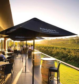 a restaurant with people sitting at tables and an umbrella