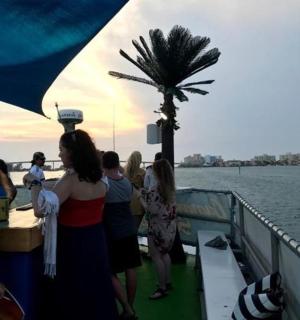 a group of people standing on a boat on the water