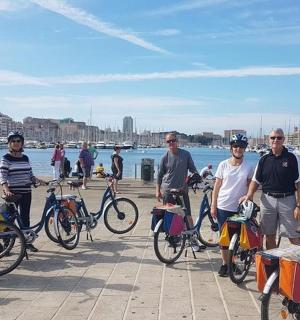 a group of people standing with their bikes on a pier