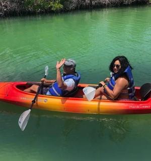 a man and a woman in a kayak on the water