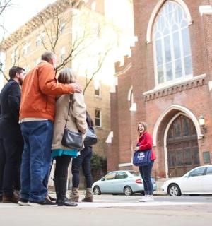 一群人站在建筑物前的人行道上