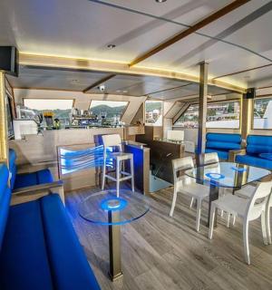 a room with a table and chairs in a boat